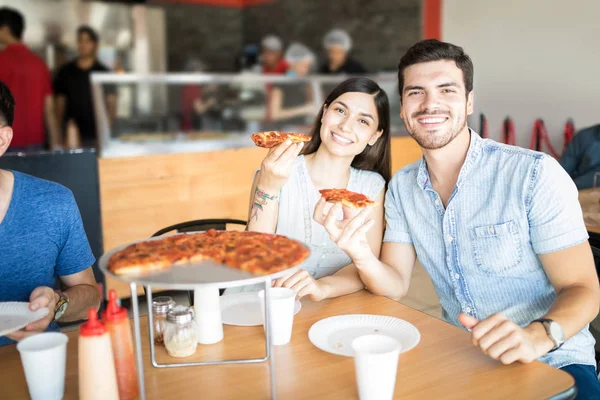 Χαρούμενα Άνδρας Και Γυναίκα Κρατώντας Κομμάτι Πίτσα Ενώ Κάθεται Στο — Φωτογραφία Αρχείου