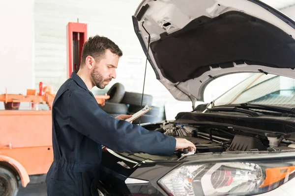 Side View Male Auto Mechanic Checklist Examining Car Engine Repair — Stock Photo, Image