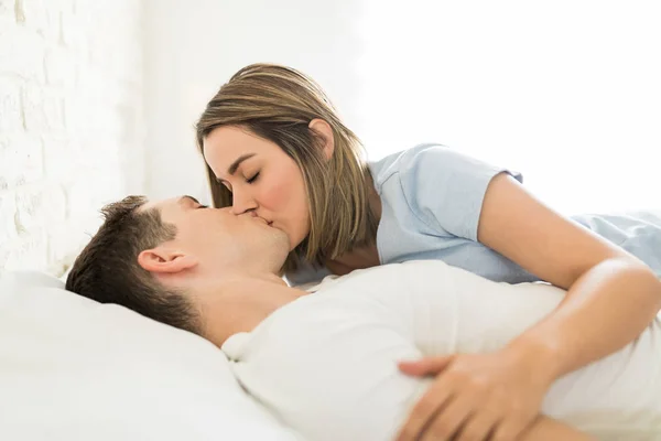 Romantic Female Kissing Man Mouth While Reclining Bed Home — Stock Photo, Image