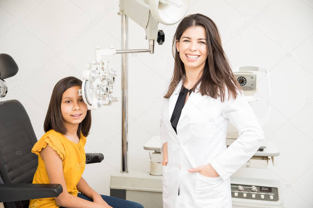 Little girl with beautiful doctor at the ophthalmologist for consultation on eye checkup
