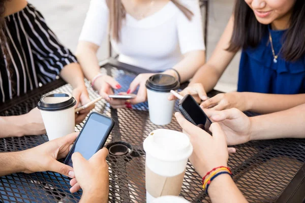 Group Friends Sitting Outdoors Cafe Using Phones Cups Coffee Table — Stock Photo, Image