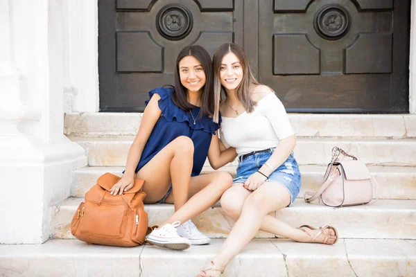 Portrait Two Teenage Girls Casuals Sitting Together Outdoors Looking Camera — Stock Photo, Image