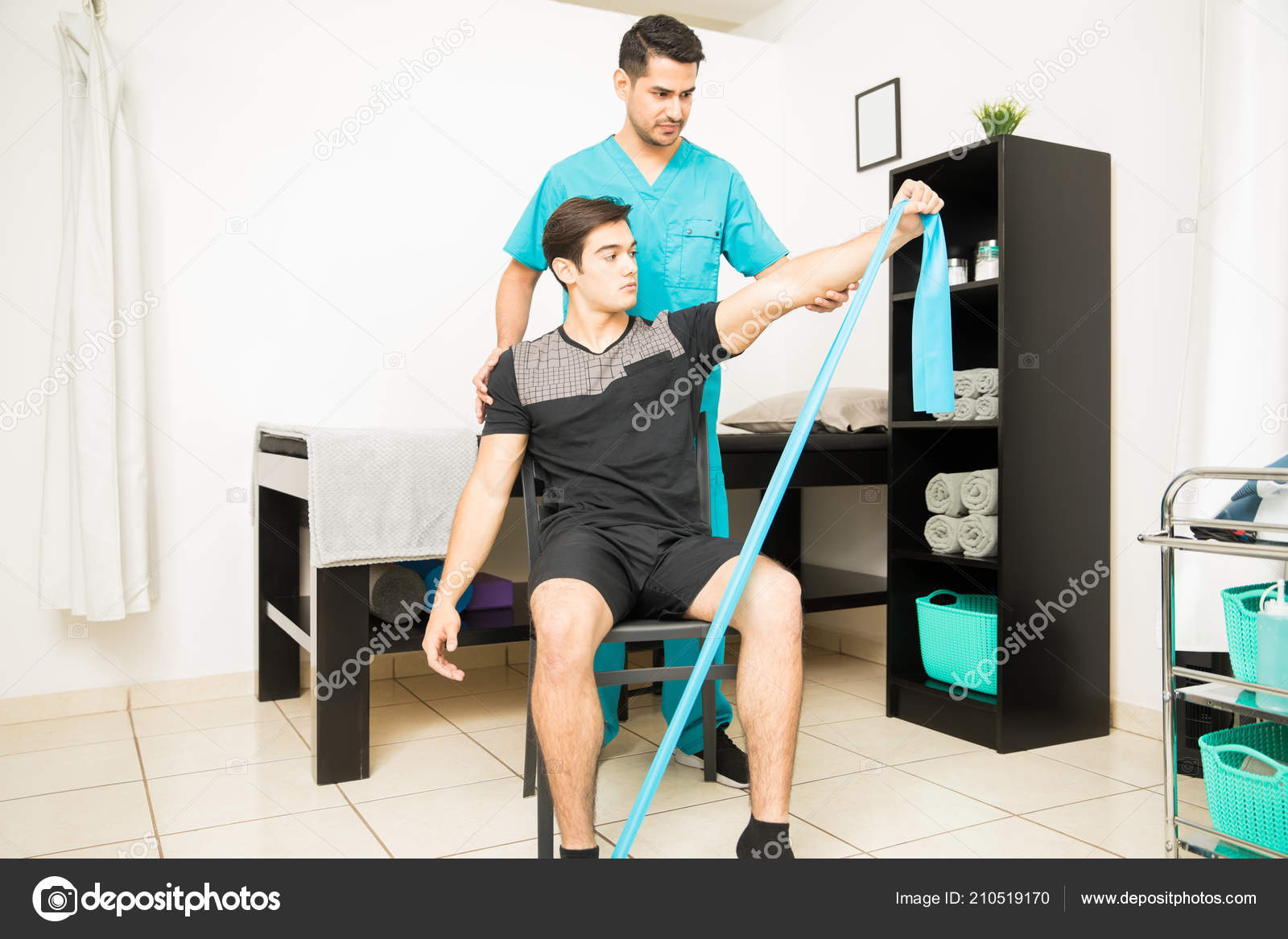 Physiotherapist Assisting Young Athlete Performing Stretching