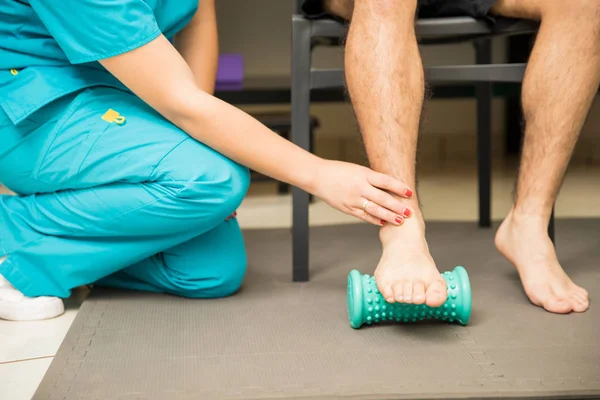 Low Section Female Therapist Assisting Patient Use Foot Roller Plantar — Stock Photo, Image