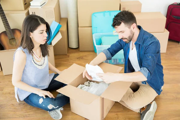 Mid Adult Male Female Taking Out Stuff Corrugated Box While — Stock Photo, Image