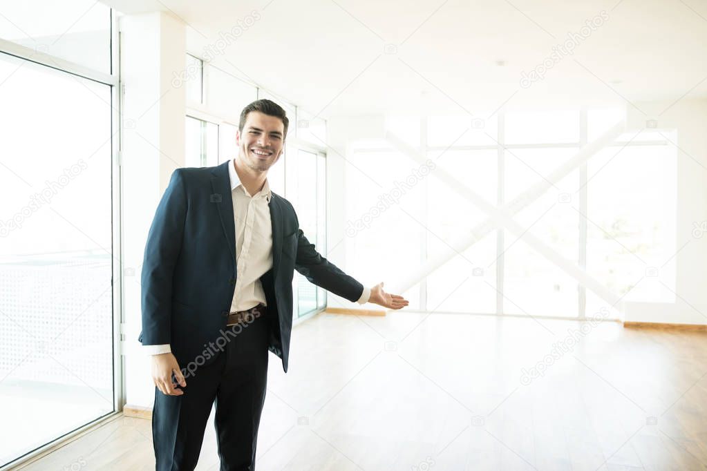Portrait of smiling broker welcoming in new apartment