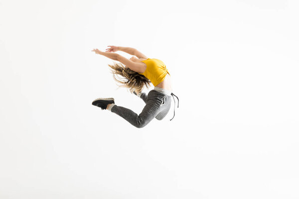 Female break dancer showing off some of her dance moves over white background
