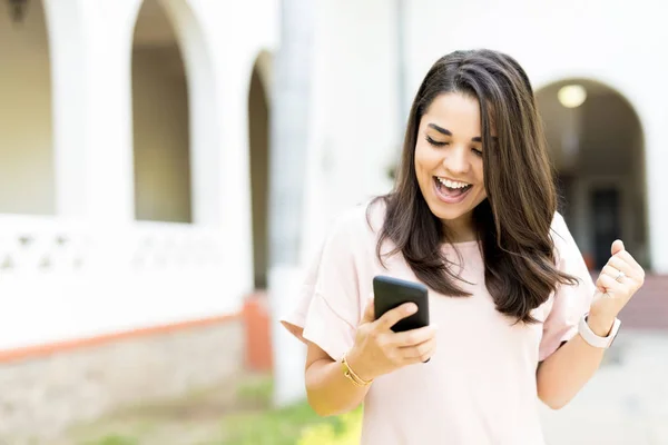 Excited Mid Adult Woman Receiving Good News Smartphone Outdoors — Stock Photo, Image