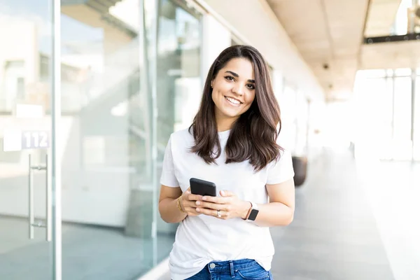 Retrato Mulher Sorrindo Enquanto Segurava Telefone Celular Shopping Center Durante — Fotografia de Stock