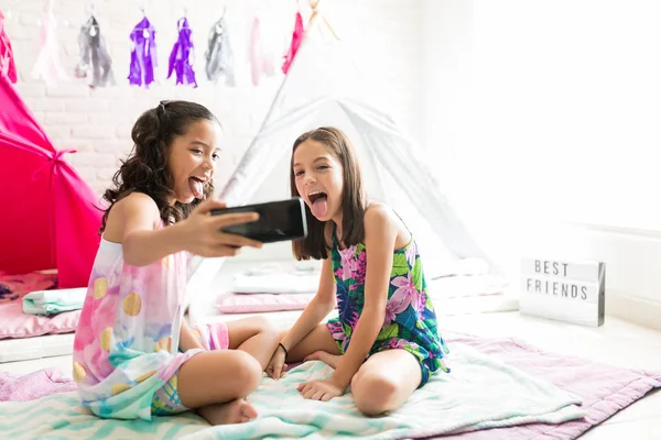 Mischievous Girls Sticking Out Tongue While Taking Selfie Smartphone Pajama — Stock Photo, Image