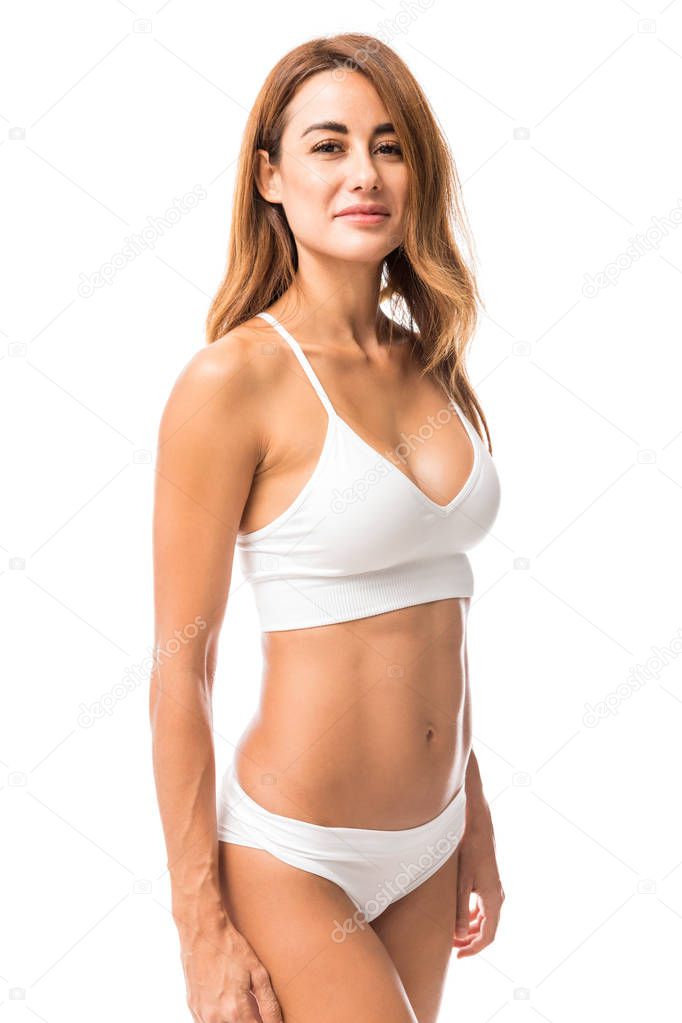 Portrait of sexy woman with athletic body smiling over white background