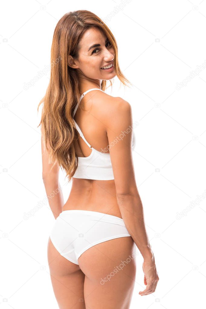 Portrait of mid adult woman with beautiful and strong back standing against white background