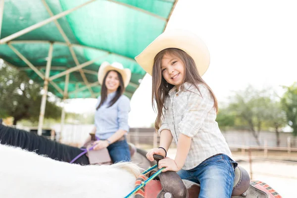 Portrait Happy Little Girl Wearing Hat While Riding Horse Mother — Stock Photo, Image