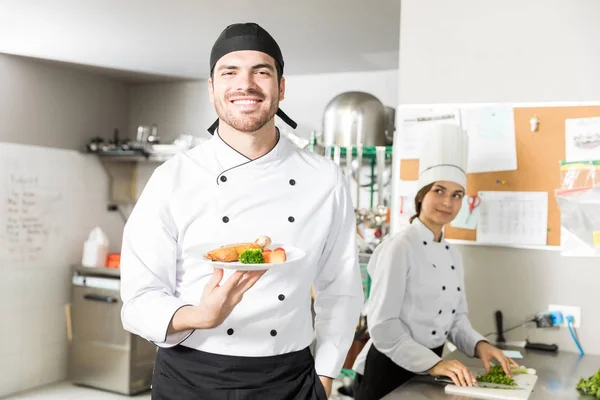 Portrait Young Smiling Cook Holding Food Plate Kitchen — Stock Photo, Image