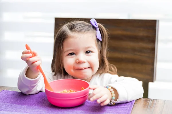 Cute Female Toddler Smiling While Having Noodles Dining Table — Stock Photo, Image