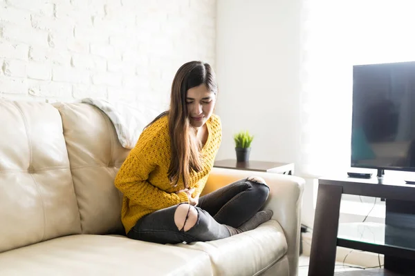 Young Woman Suffering Period Pain Sofa Home — Stock Photo, Image