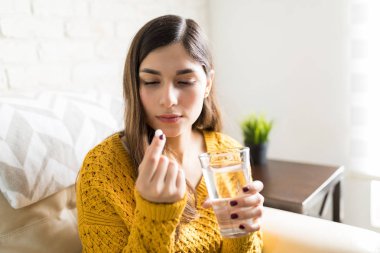 Oldukça hap oturma odasında su cam tutarken arayan kadın hasta