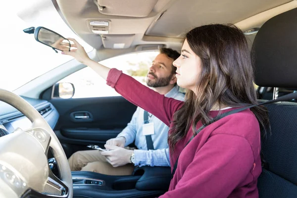 Attraente Studentessa Regolazione Auto Retrovisore Durante Lezione Guida — Foto Stock