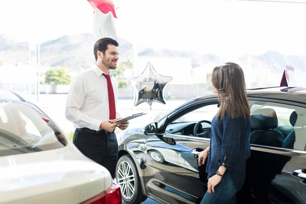 Attractive Salesman Giving Information Woman Expensive Car Salon — Stock Photo, Image