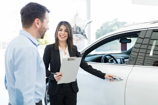 Attractive Sales Worker Opening Car Door Mid Adult Client Showroom — Stock Photo, Image