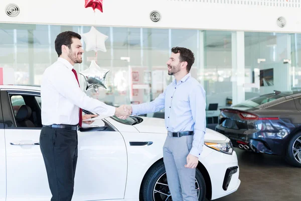 Handsome Salesman Greeting Mid Adult Man New Car Showroom — Stock Photo, Image