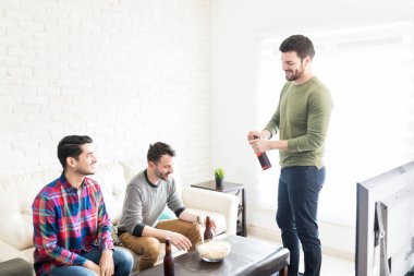 Genç adam bira şişesi arkadaşlar tarafından açılış hafta sonu partisi sırasında evde