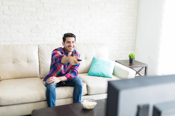 Hispanic Attractive Man Using Remote Control While Spending Weekend Home — Stock Photo, Image