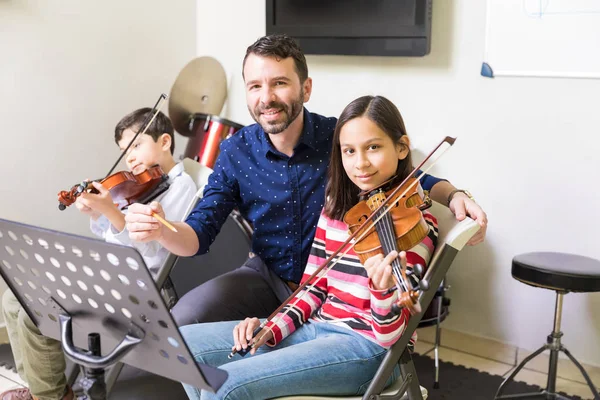 Portrait Mid Adult Tutor Male Female Students Sitting Violin Class — Stock Photo, Image