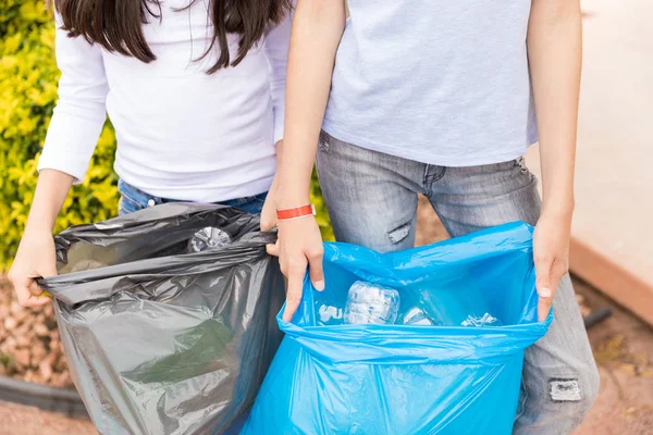 Midsection Girls Casuals Showing Waste Garbage Bags Yard — Stock Photo, Image
