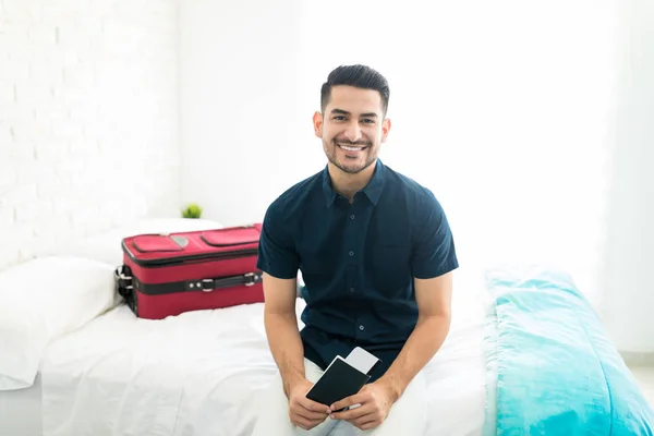 Attractive Young Man Smiling While Holding Passport Air Ticket Bedroom — Stock Photo, Image