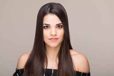Bej arka plan üzerinde sağlıklı kahverengi saçlı sevimli orta yetişkin kadının Closeup