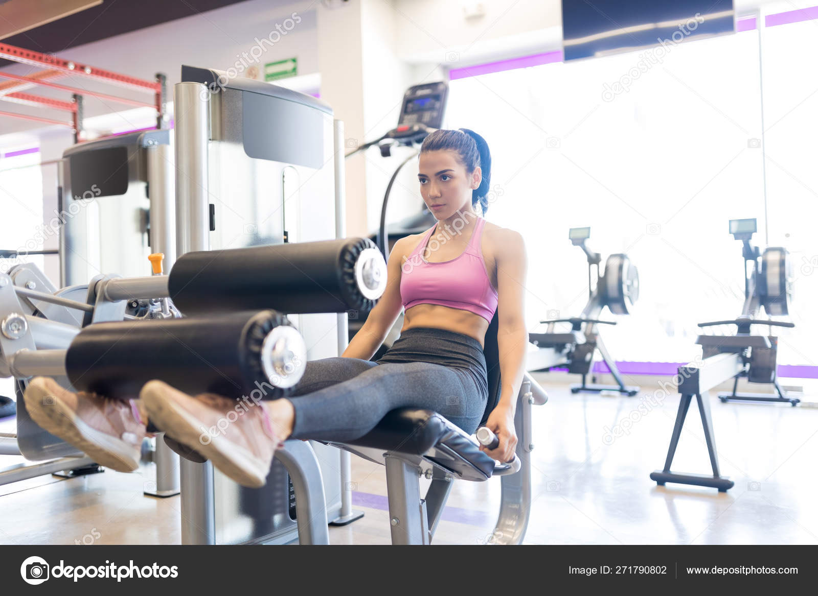 Ambitious Woman Lifting Heavy Weights Legs While Sitting Exercise Equipment Stock Photo tonodiaz 271790802