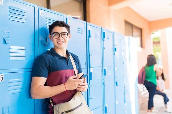 Portrait Smiling Male Student Smartphone Standing Lockers Hallway — ストック写真