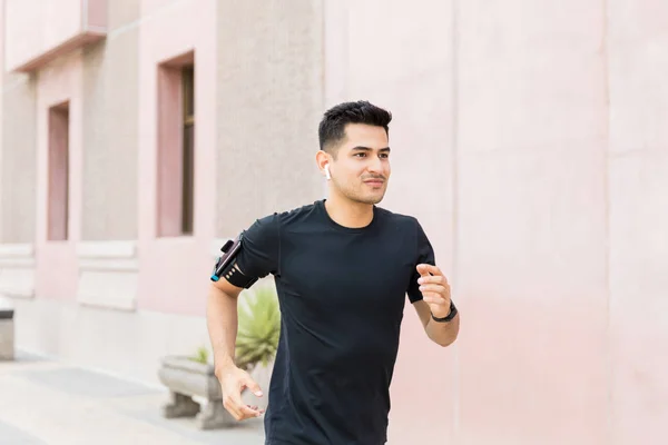 Säker Manlig Löpare Jogging Medan Njuter Musik Träningen — Stockfoto