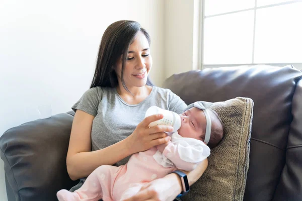 Mid Adult Mother Feeding Milk Her Baby Girl Bottle Sofa — Stock Photo, Image