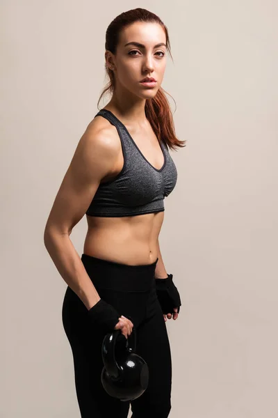 Retrato Jovem Desportista Exercitando Com Kettlebell Contra Fundo Marrom — Fotografia de Stock