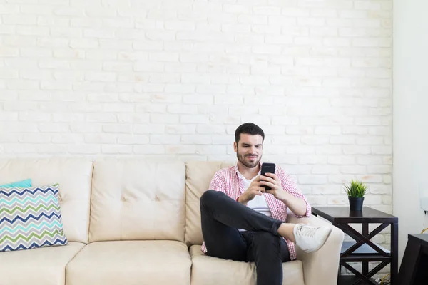 Male Blogger Sitting Sofa While Checking His Social Media Status — Stock Photo, Image