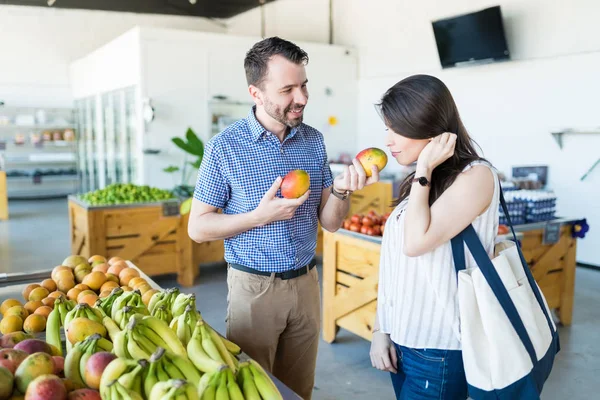 Άνθρωπος Δείχνει Φρέσκα Μάνγκο Φιλενάδα Ενώ Αγοράζουν Φρούτα Βιολογικό Κατάστημα — Φωτογραφία Αρχείου