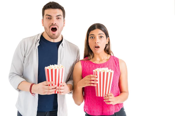 Shocked Latin Young Couple Watching Thriller Movie While Holding Popcorn — Stock Photo, Image