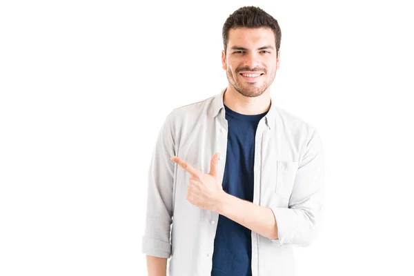 Portrait Fashionable Young Hispanic Man Pointing While Standing Studio — Stok Foto