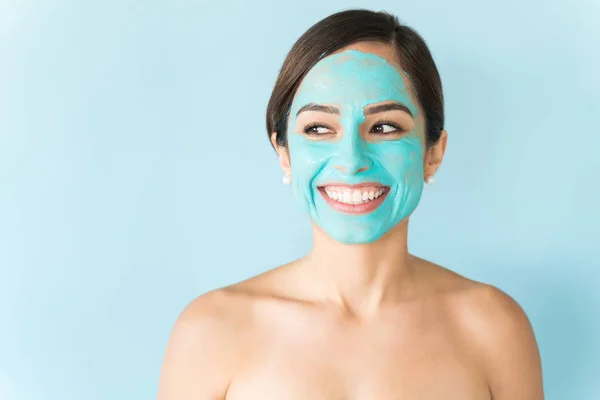 Happy Naked Woman Facial Mask Looking Away Blue Background — Stok Foto