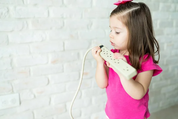 Nyfiken Söt Kvinnlig Småbarn Tittar Elkabel Medan Står Vid Väggen — Stockfoto