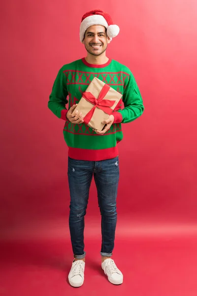 Full Length Attractive Young Male Holding Christmas Gift While Making — Stock Photo, Image