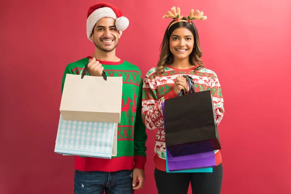 Gorgeous Young Latin Couple Holding Shopping Bags While Making Eye — Stock Photo, Image