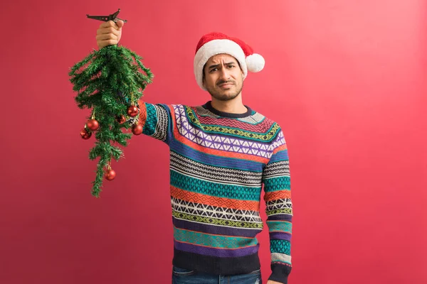 Upset Young Handsome Man Holding Christmas Tree Upside Red Background — Stock Photo, Image
