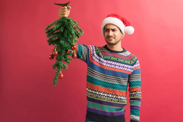 Displeased Attractive Young Male Holding Small Christmas Tree Isolated Studio — Stock Photo, Image