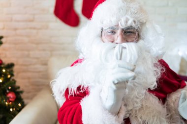 Noel sırasında evde gesturing Noel Baba gibi giyinmiş adam portresi