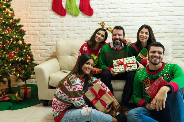 Portrait Mid Adult Friends Wearing Ugly Sweater Holding Gifts Living — Stock Photo, Image