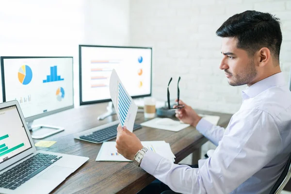 Attractive Young Male Sales Professional Analyzing Chart While Holding Paper — Stock Photo, Image