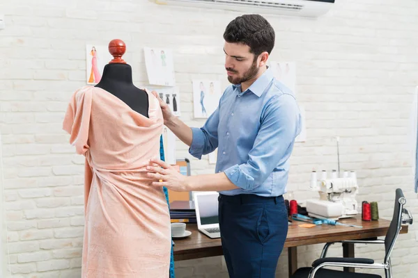 Young Male Dressmaker Examining New Dress Style Dummy While Standing — Stock Photo, Image